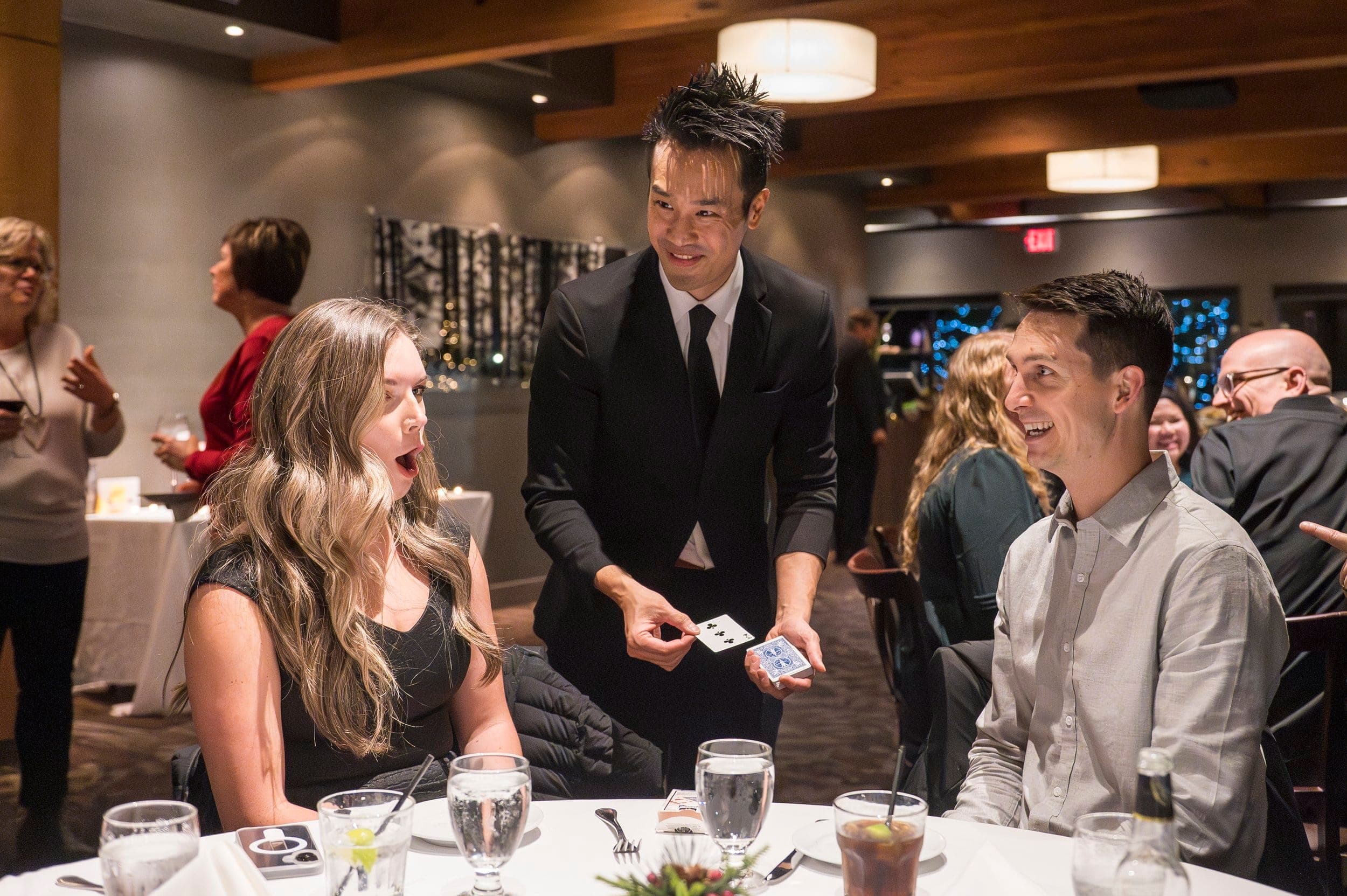 Kel performing close-up magic with McDonald's Canada staff at their Hilton celebration in Vancouver
