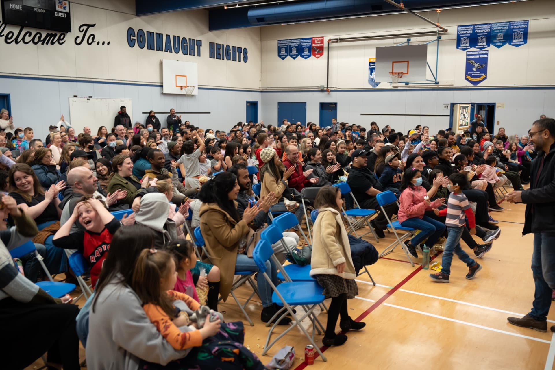 A packed school gym of families watching the fundraiser magic show at Connaught Heights Elementary