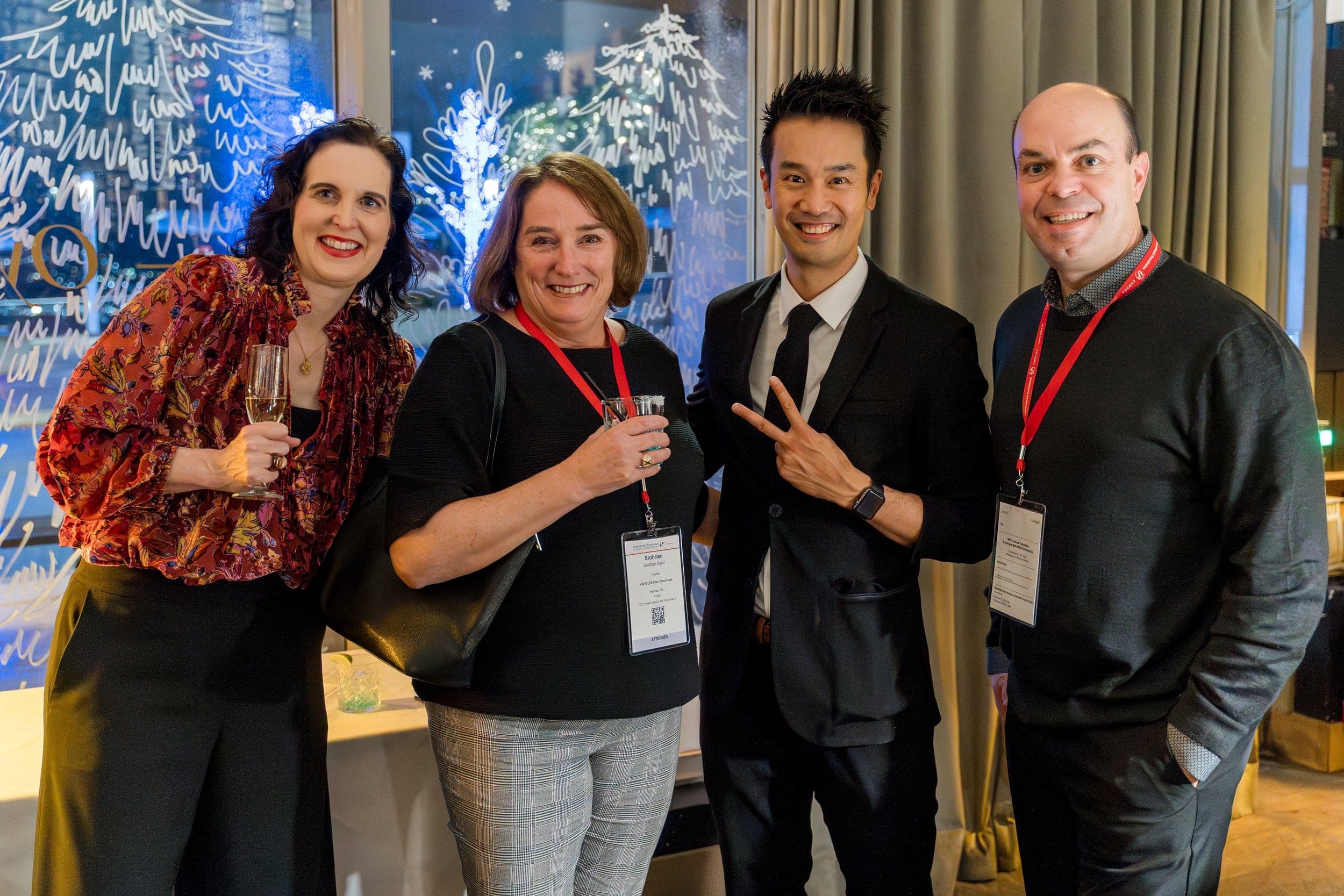 Kel with guests wearing conference lanyards at an insurance company's winter party in Vancouver