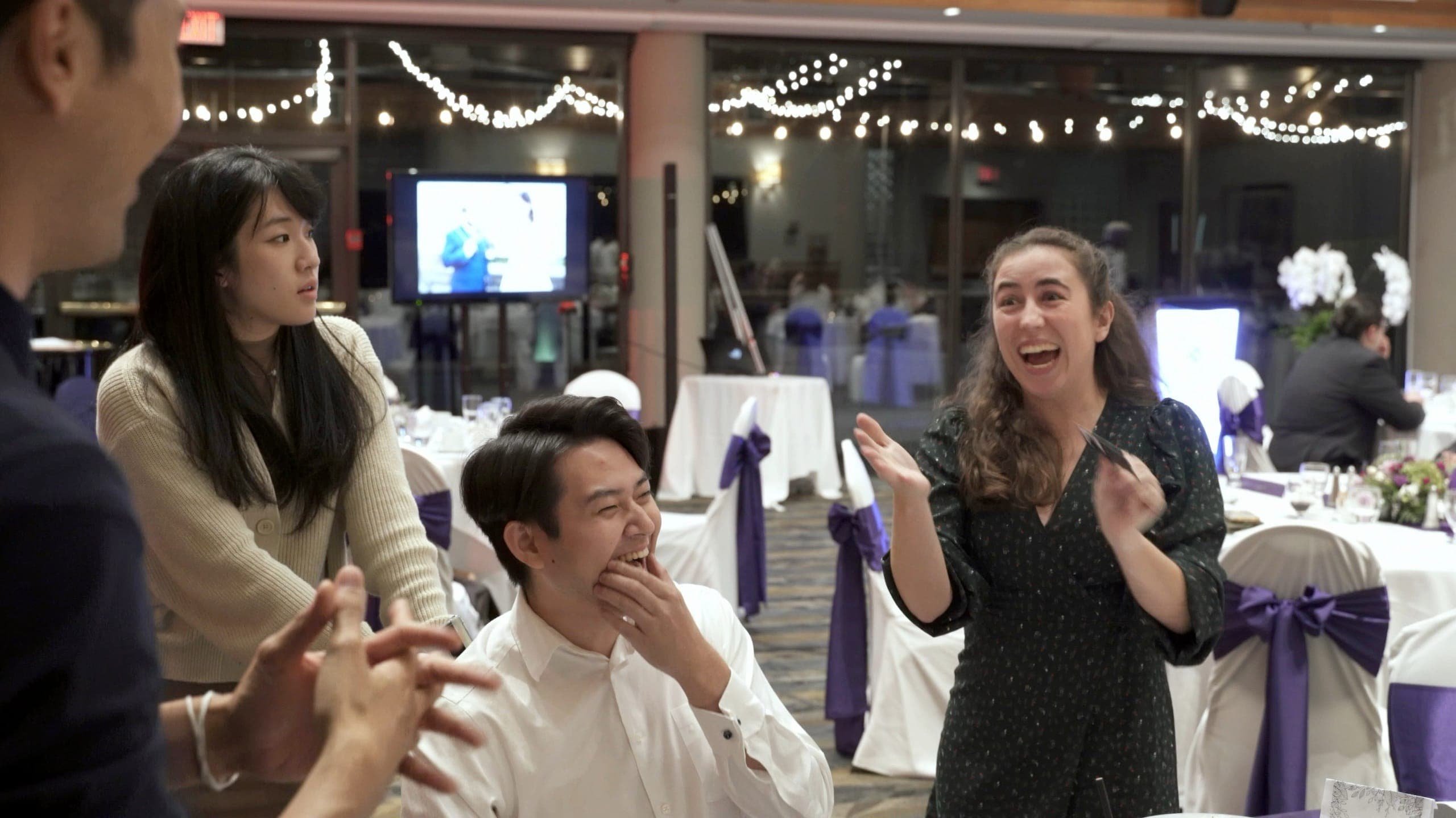 Guests reacting with delight during a mentalism performance at a Vancouver event