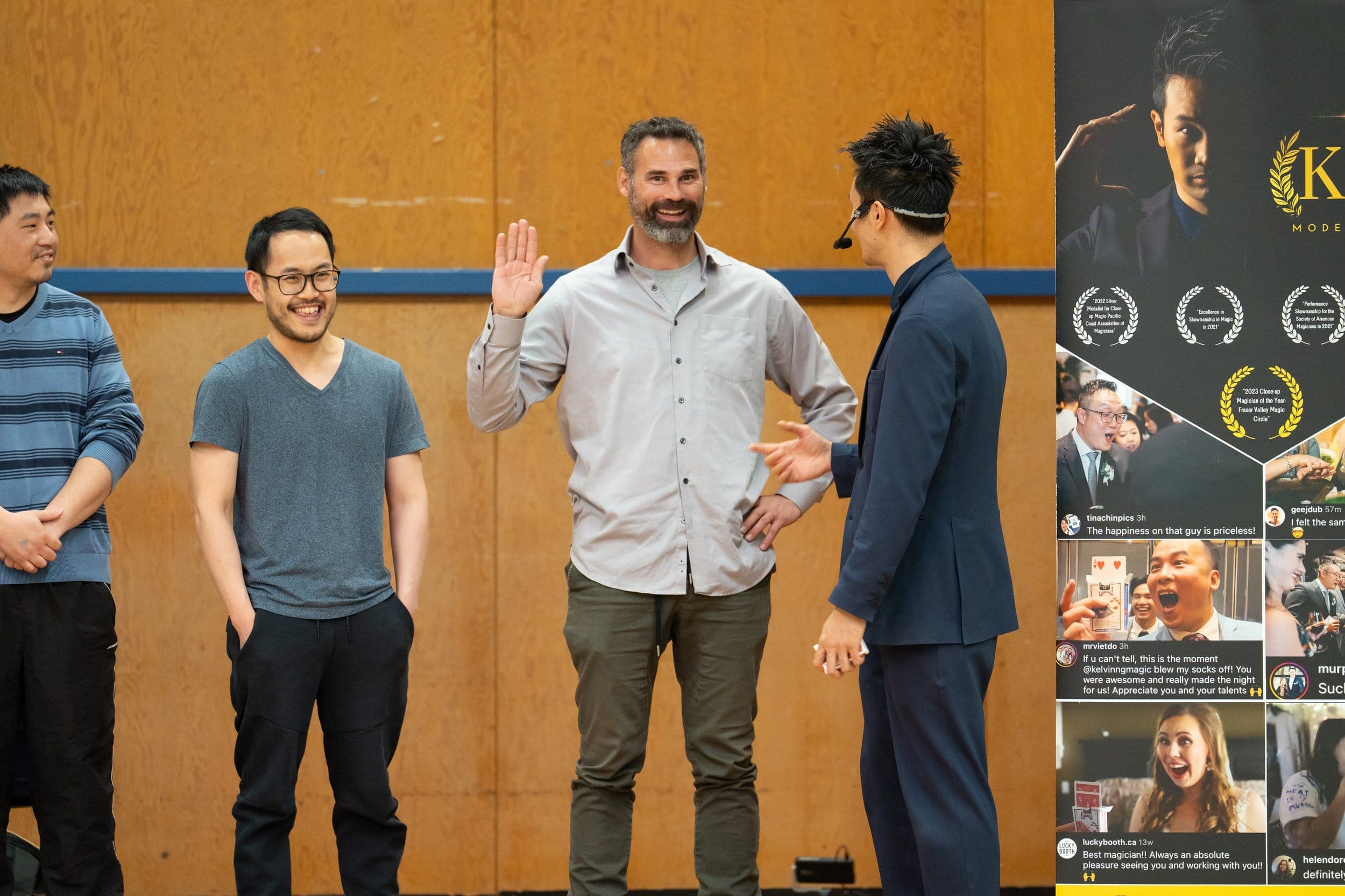 Kel running a participation routine with three volunteers, beside a collage of show posters