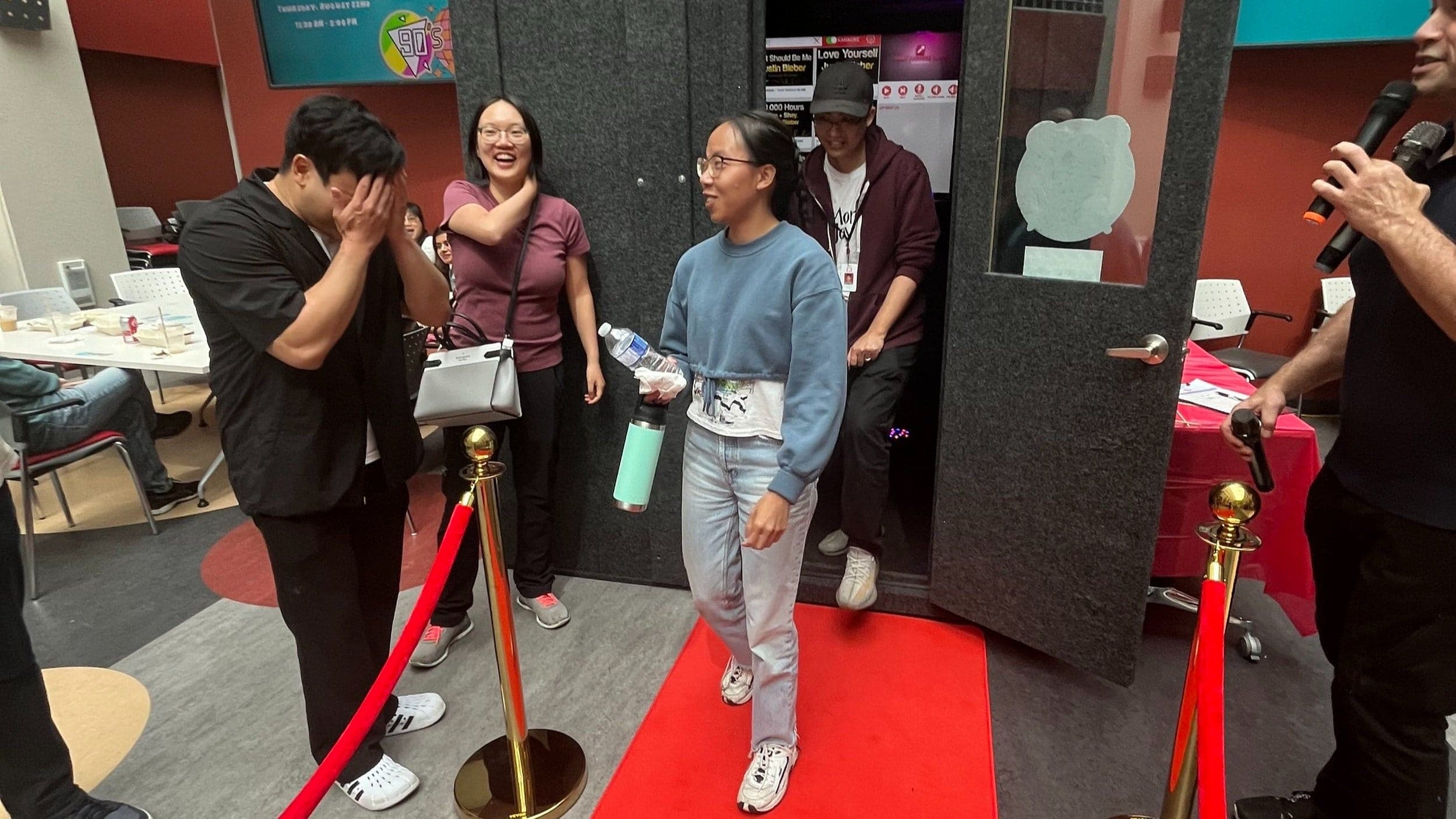Guests laughing beside the Party Karaoke Box on a red carpet at a Vancouver corporate event