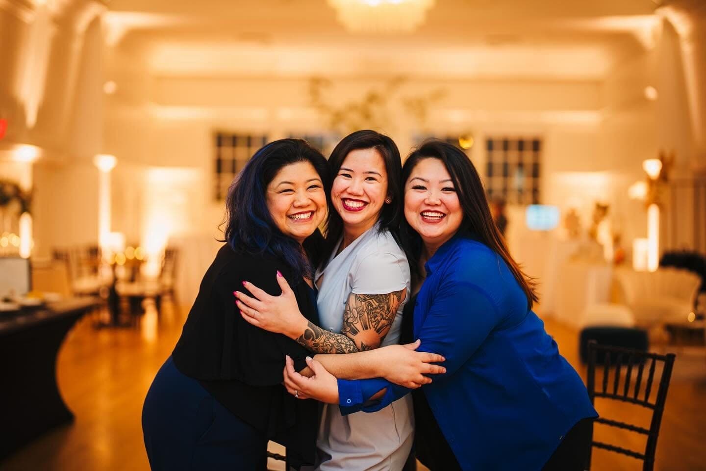 Vinelli, Kimberly and Sammie Jo Rumbaua of Power of Three hugging and laughing at a Vancouver venue