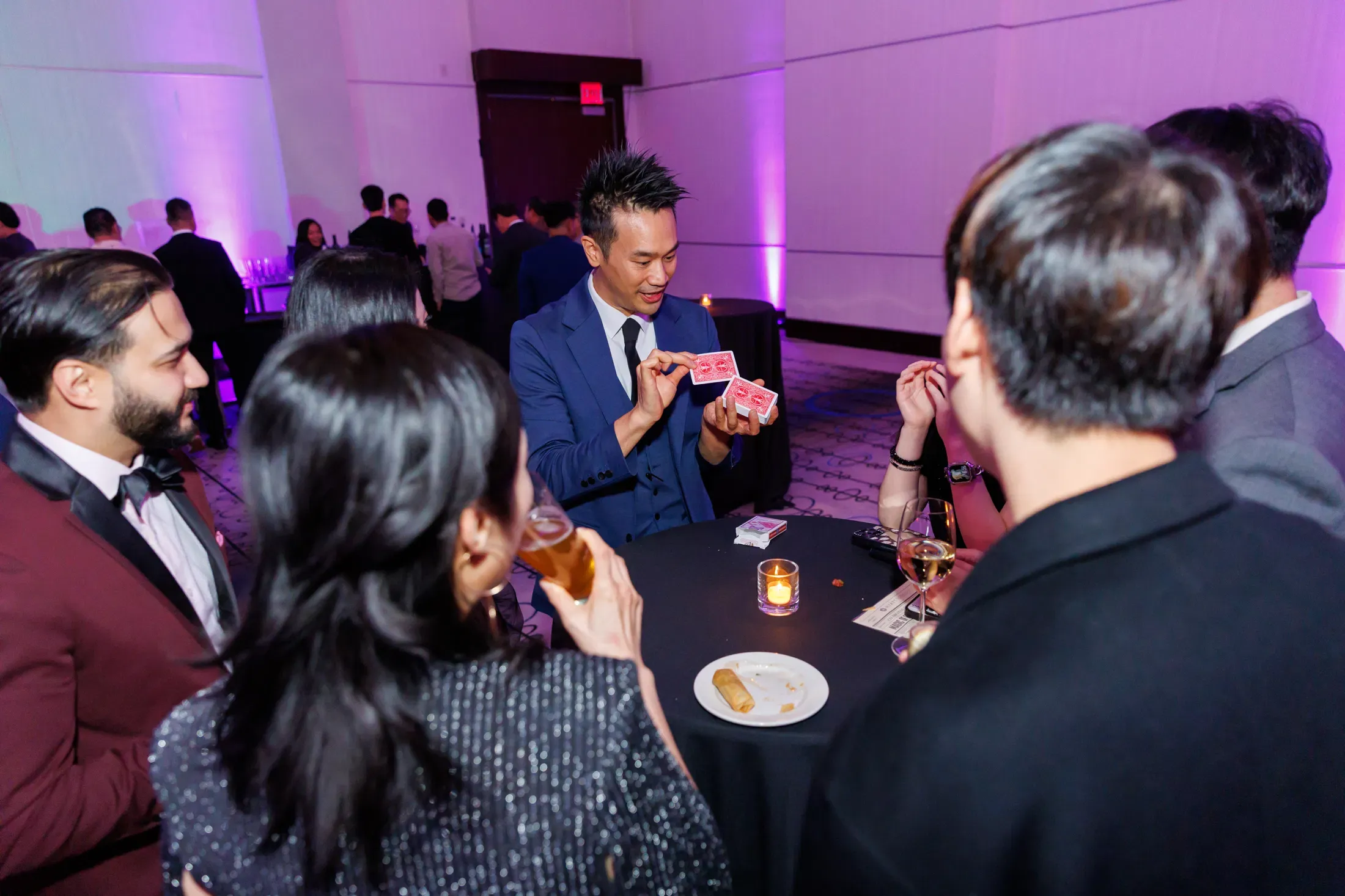 Guests at the Hyatt Regency Vancouver watching close-up magic during the Endeavour Silver corporate event