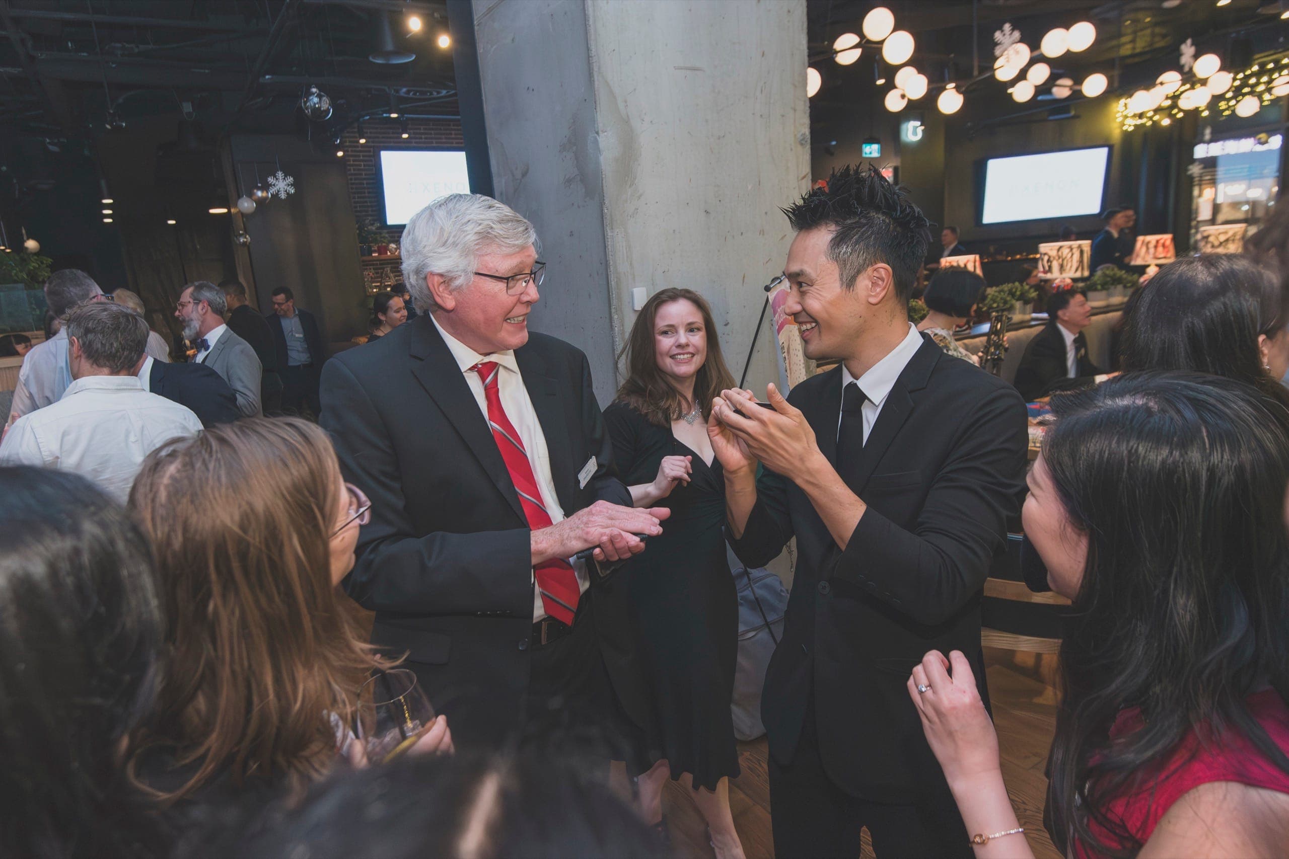 Kel performing close-up magic for guests at a Xenon Pharmaceutics corporate event in Vancouver